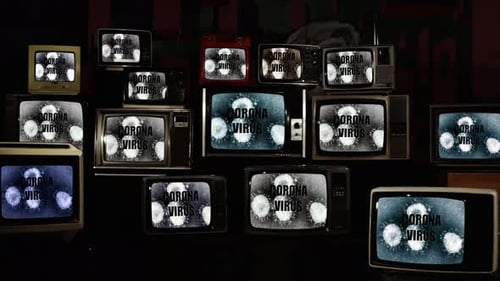 Wall of Vintage Televisions Displaying Static and Text