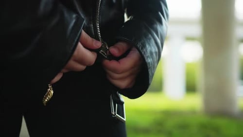 Close Up Girl Closing Zipper on Black Leather Jacket. Rock Girl Wearing Black Leather Jacket