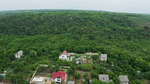 Aerial Footage of Flying Over Residential Rurual Area Then Over a Forest