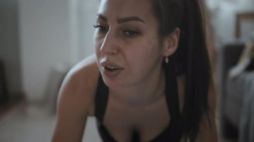 Woman Doing Pushups on Yoga Mat at Home
