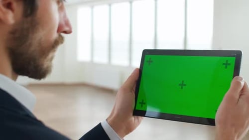An Designer Scans the Office Space with the Help of Additional Reality Using the Digital Tablet