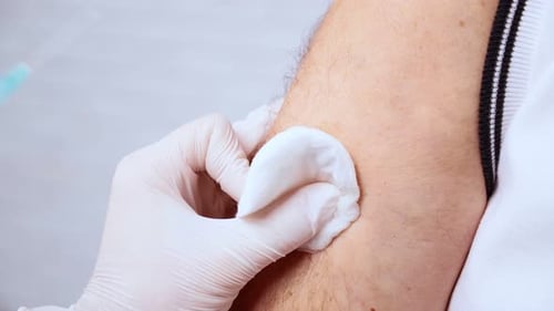 Medical Professional Giving Injection to Arm