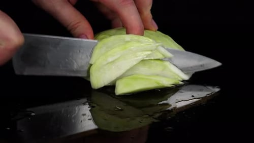 Slicing Fresh Cabbage with Knife in Close Up