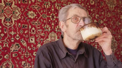 Senior Beggar Man Drinking Tea Alone