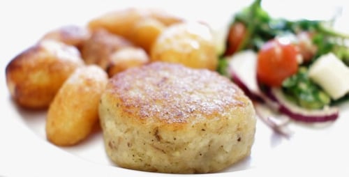Potato Cake with Roasted Potatoes and Salad Being Cut