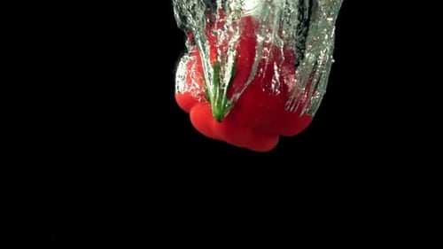 Super Slow Motion Red Bell Pepper Falls Under the Water with Air Bubbles