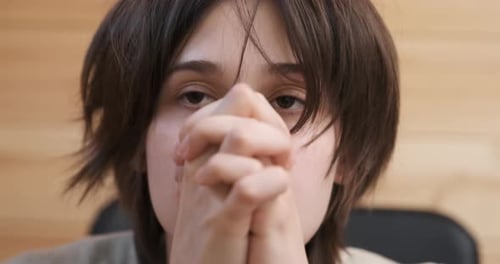 Distressed Woman With Head in Hands