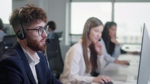 Customer Service Representatives Working in Modern Office