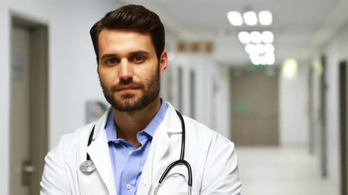 Doctor Smiles Confidently in Hospital Setting