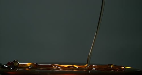 Honey Flowing against Black Background, Slow Motion 4K