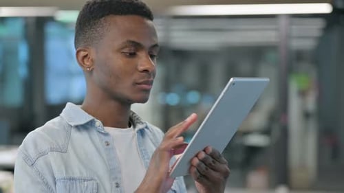 Young Adult Using Tablet in Office Close Up