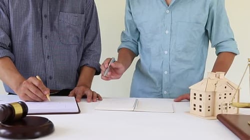 Lawyer meet with client to discuss housing and real estate.