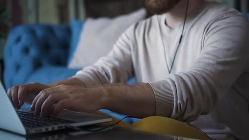 Young Man Working on Laptop at Home