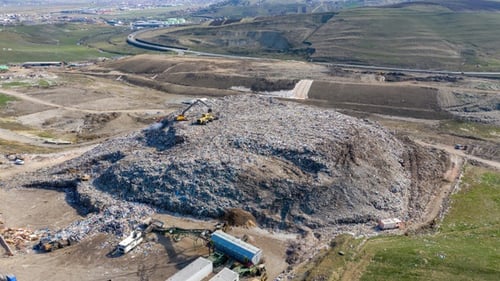Aerial View of Expansive Landfill Site in Daytime