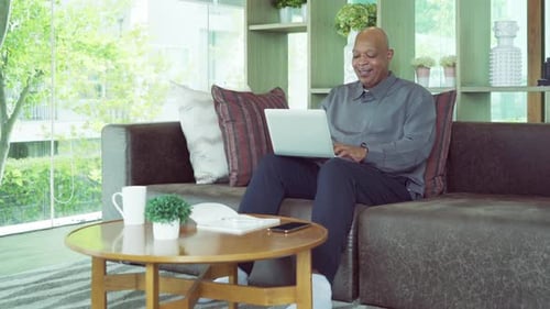 Adult Man Working on Laptop at Home