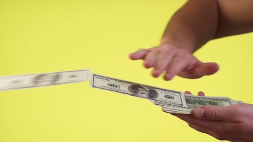 Hands Are Throws Dollars, Scattering Cash, Wasting Money Carelessly. Closed Studio Shot Isolated on