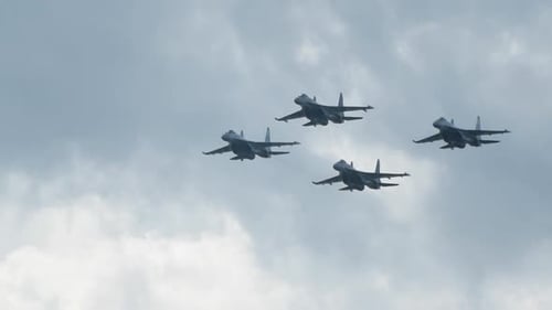 Jets Flying in Formation Against Cloudy Sky