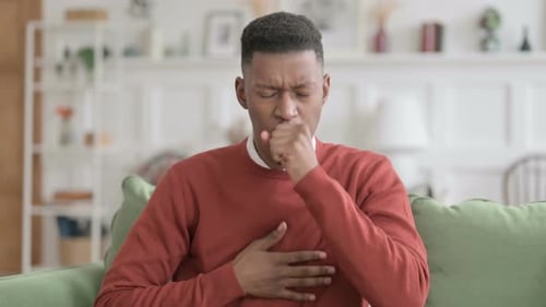 Young Adult Coughing Due to Sickness