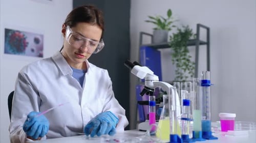Female Scientist Working with Microscope in Laboratory