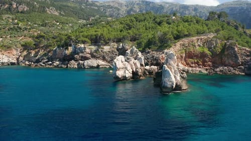 Drone Over Blue Sea Towards Rocks And Coastline Of Ibiza