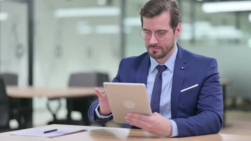 Businessman Works with Tablet in Modern Office