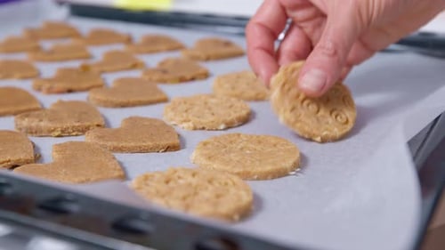 Arranging Heart and Round Cookie Dough on Tray