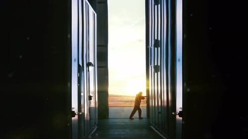 Worker opening Metal Door of a Container Depot at Sunset.
