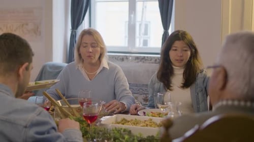 Family Meal Together Around Dining Table at Home