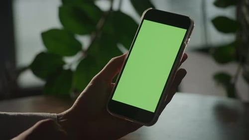 Handheld Close Up of Woman Hands Holding a Smart Phone with Green Screen Chroma Key