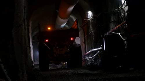 Large construction trucks working inside a tunnel
