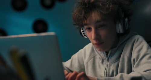 A Child Designs a Building for Tech Class Does Homework Draws with a Pencil in a Notebook Looks at a