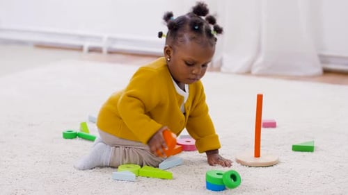 Adorable Infant Plays with Colorful Wooden Blocks