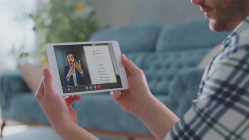 Man Using Tablet for Online Meeting at Home