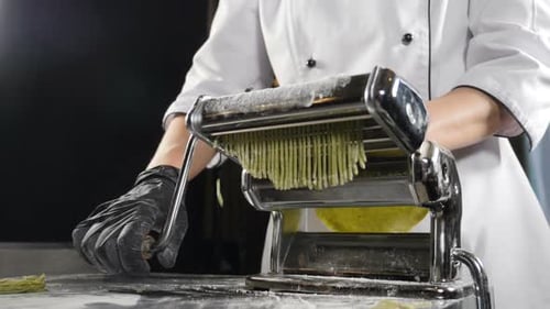 Chef Making Fresh Pasta with a Pasta Machine