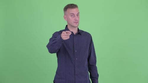 Happy Handsome Businessman Pointing at Camera