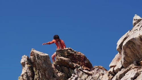 Young Man Having an Adventure - Standing on the Mountain and Looking Around