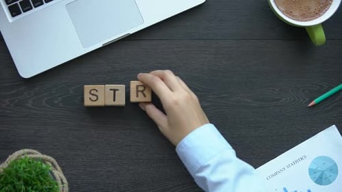 Strategy Spelled Out with Wooden Blocks on Desk