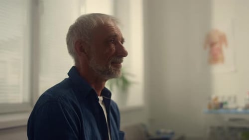 Elderly Patient Discussing Woman Doctor Health Complaints in Hospital Close Up