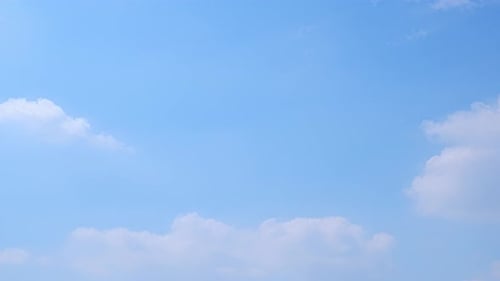 Bright Blue Sky with Soft White Clouds