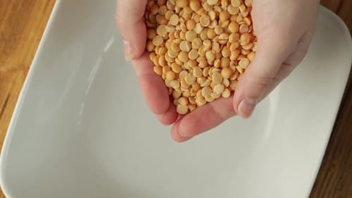 Pouring Yellow Split Peas into a Bowl