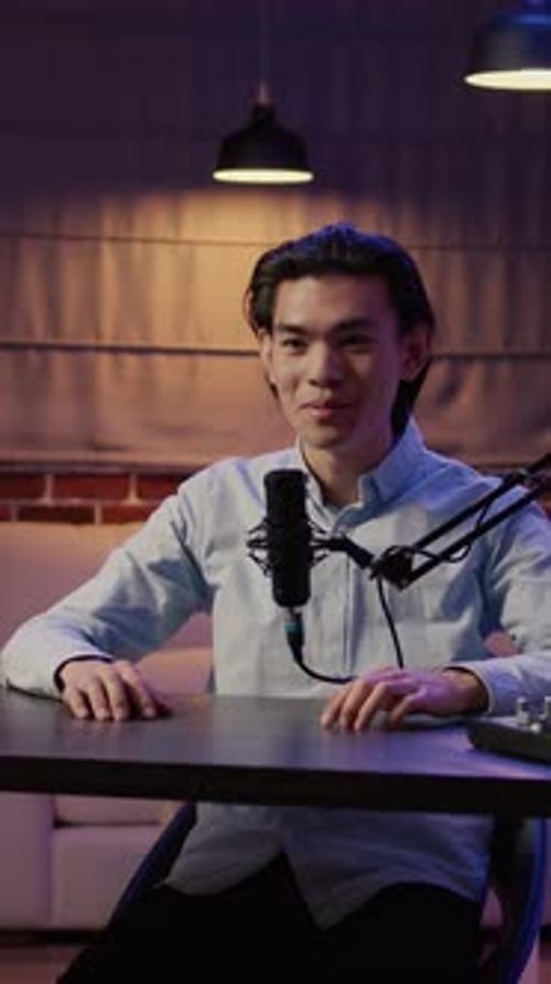 Man Recording Podcast in Studio at Night