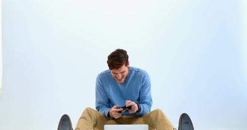 Young Adult Man Plays Video Game in Studio