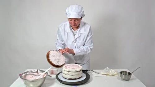 Woman Assembles Layer Cake in Kitchen