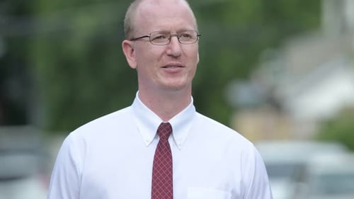 Man Smiling in White Shirt and Tie