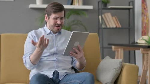 Man Receives Good News on Tablet at Home
