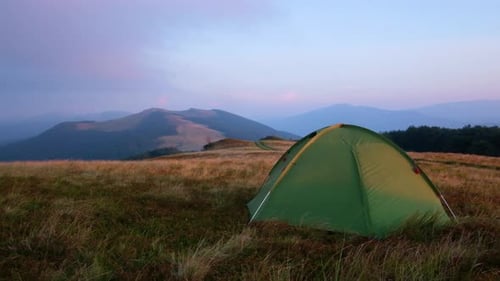 Green Tent Camping in Mountain Landscape at Sunrise