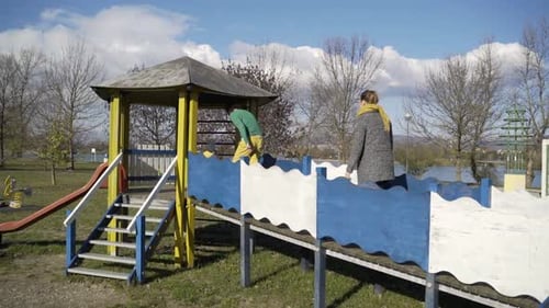 Family playing in public playground, Zagreb, Croatia.