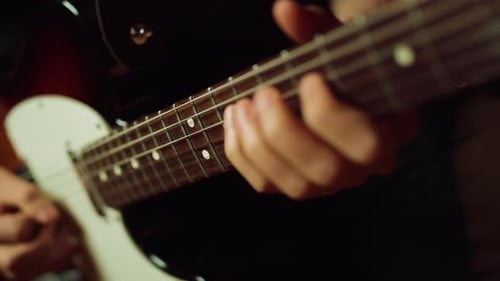 Musician Playing Electric Guitar in Studio. Guitarist Hand Pinching Chords