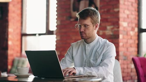 Male Professional Typing on Laptop Keyboard at Office Workplace