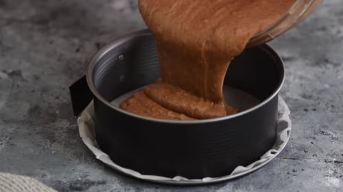 Chocolate Cake Batter Being Poured Into Tin
